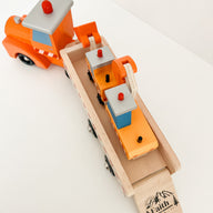 wooden toy construction trucks with the words faith can move mountains printed on the ramp.