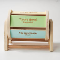 Colorful wooden spinning drum where each side of the drum features an affirmation bible verse.