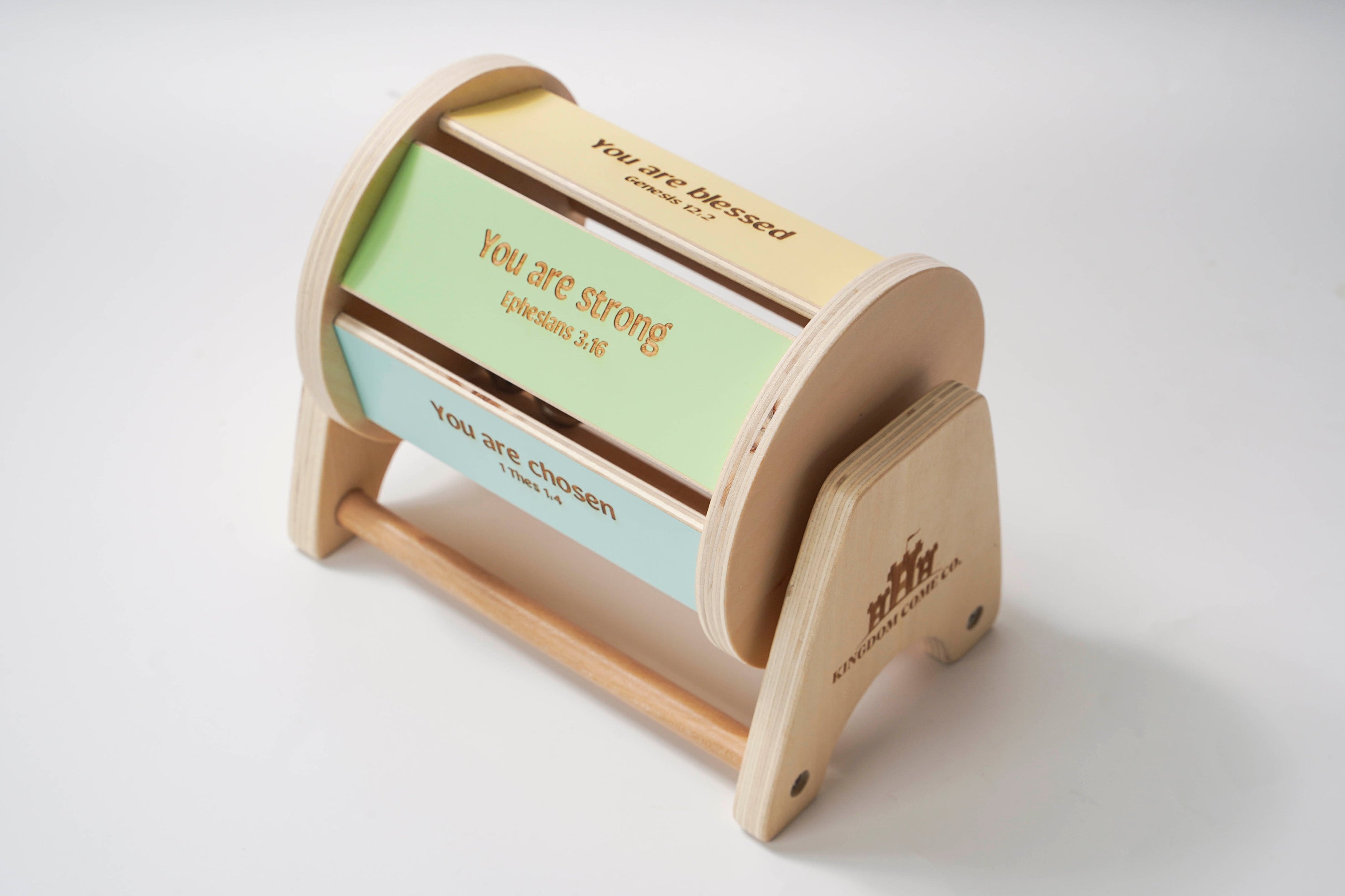 Wooden spinning baby drum features an affirmation bible verse.