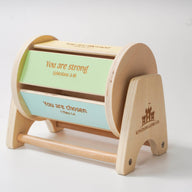 Montessori inspired wooden spinning drum where each panel on the drum features an affirmation bible verse.